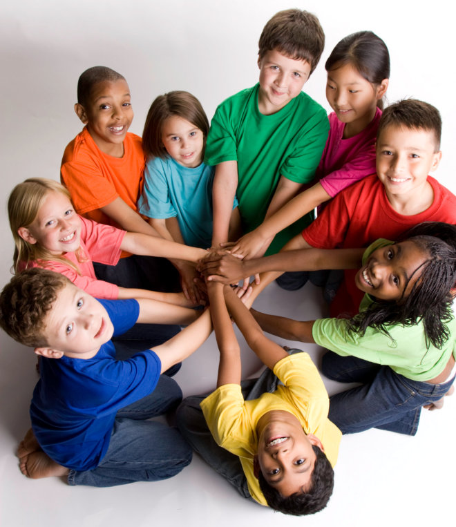 children putting their hands in the center